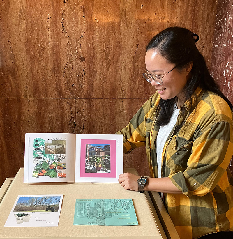 Naomi Kuo poses next to her artwork