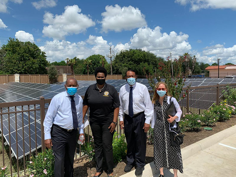 Mayor Turner and Councilwoman Martha Castex-Tatum stand in front of the solar panels
